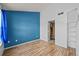 Bedroom features vinyl wood flooring, closet with shelving, and bathroom access at 17118 E Whitaker Dr # E, Aurora, CO 80015