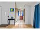 View of the home's entrance showcasing hardwood floors and an adjacent kitchen at 17118 E Whitaker Dr # E, Aurora, CO 80015