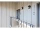 Close-up of condo door with house numbers and exterior lighting at 17118 E Whitaker Dr # E, Aurora, CO 80015