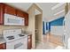 Kitchen with white range and microwave oven showing view to living area at 17118 E Whitaker Dr # E, Aurora, CO 80015