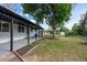 Lush backyard featuring a covered patio and mature tree; a perfect setting for outdoor gatherings and relaxation at 5041 S Julian St, Englewood, CO 80110