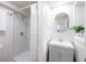 Updated bathroom with white tiles, vanity, and glass shower at 5041 S Julian St, Englewood, CO 80110