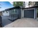 Charming home exterior with modern siding, a gray-toned garage, and beautifully landscaped front yard at 5041 S Julian St, Englewood, CO 80110