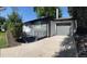 Well-maintained home exterior with a driveway and attached garage provides convenience and curb appeal at 5041 S Julian St, Englewood, CO 80110