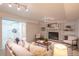 Cozy living room with brick fireplace and open access to the kitchen at 5041 S Julian St, Englewood, CO 80110