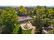 Aerial shot of neighborhood park with playground, tennis courts, and mature trees at 12008 E Amherst Pl, Aurora, CO 80014