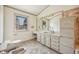 Bright bathroom features a vanity, window, and tiled floors at 12008 E Amherst Pl, Aurora, CO 80014