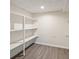 Walk-in closet boasts built-in shelving and laminate wood flooring at 12008 E Amherst Pl, Aurora, CO 80014