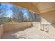 An outdoor deck with built in cabinets looks out over mature trees and landscaping at 12008 E Amherst Pl, Aurora, CO 80014