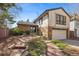Charming two-story home with brick accents and a beautifully landscaped front yard at 12008 E Amherst Pl, Aurora, CO 80014