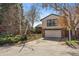 Well-maintained home featuring a two-car garage and mature trees in a suburban setting at 12008 E Amherst Pl, Aurora, CO 80014