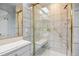 Bathroom with a glass shower enclosure with gold trim and marble tile at 12008 E Amherst Pl, Aurora, CO 80014