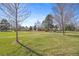 Expansive green lawns and mature trees at 12008 E Amherst Pl, Aurora, CO 80014