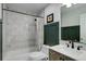 Modern bathroom featuring marble tile, sleek vanity, and shower-tub combo with elegant curtain at 12229 Circle Dr, Conifer, CO 80433