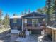 Charming elevated home with a covered porch and scenic wooded views, perfect for enjoying the outdoors at 12229 Circle Dr, Conifer, CO 80433