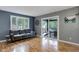 Cozy living room featuring hardwood floors, a comfortable sofa, and a sliding door to a spacious deck at 12229 Circle Dr, Conifer, CO 80433