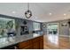 Open-concept living space with hardwood floors, stylish lighting, a black leather sofa and access to the deck at 12229 Circle Dr, Conifer, CO 80433