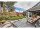 Serene backyard featuring a lush lawn, stepping stones, and shaded patio area for outdoor enjoyment at 1538 Albion St, Denver, CO 80220