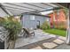 Backyard patio featuring comfortable seating, a grill, lush greenery, and stepping stone pathway at 1538 Albion St, Denver, CO 80220
