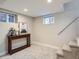 Finished basement area featuring neutral carpet, updated lighting, and tasteful decor at 1538 Albion St, Denver, CO 80220