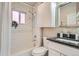 Bathroom with subway tile surround tub, dark granite counters and modern fixtures at 1538 Albion St, Denver, CO 80220