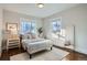 Bright bedroom with hardwood floors, and ample natural light from two large windows at 1538 Albion St, Denver, CO 80220
