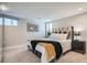 Comfortable bedroom with plush carpeting, modern decor, and natural light from two well-placed windows at 1538 Albion St, Denver, CO 80220