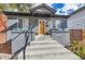 Inviting front porch with stylish lighting and a natural wood door at 1538 Albion St, Denver, CO 80220
