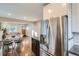 Bright, open-concept kitchen with stainless steel refrigerator and adjacent dining and living areas at 1538 Albion St, Denver, CO 80220