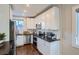 Well-lit kitchen with stainless steel appliances, granite countertops, and white cabinets at 1538 Albion St, Denver, CO 80220