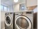 Well-lit laundry room featuring a modern washer and dryer for convenient chores at 1538 Albion St, Denver, CO 80220