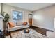 Bright living room with a comfortable sofa, modern rug, and a wooden door at 1538 Albion St, Denver, CO 80220
