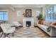 Cozy living room with a fireplace, stylish furniture, and hardwood floors at 1538 Albion St, Denver, CO 80220