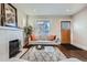 Bright living room featuring fireplace, modern furniture, hardwood floors, and natural light at 1538 Albion St, Denver, CO 80220