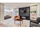 Relaxing living room area featuring custom built-ins, an entertainment center, and stylish, modern furniture at 1538 Albion St, Denver, CO 80220