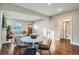 Sunlit open-concept living area with hardwood floors, a fireplace, and stylish furnishings at 1538 Albion St, Denver, CO 80220