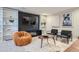 Inviting living room featuring built-in shelving, a modern entertainment center, and comfortable seating at 1538 Albion St, Denver, CO 80220