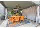 Covered outdoor dining area featuring a wooden table, comfortable seating, and a ceiling fan at 1538 Albion St, Denver, CO 80220