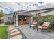 Outdoor patio with comfortable seating, a covered dining area, and beautiful landscaping at 1538 Albion St, Denver, CO 80220