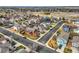 An aerial view showcases the well-maintained neighborhood with colorful houses and mature trees in a suburban setting at 6190 Sparrow Ave, Firestone, CO 80504