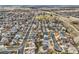 An aerial view of a suburban neighborhood with winding streets, diverse homes, and a centrally located park, highlighting community at 6190 Sparrow Ave, Firestone, CO 80504