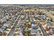 A neighborhood's aerial view displays varied home styles and landscaping, connected by streets, promoting a warm community feel at 6190 Sparrow Ave, Firestone, CO 80504