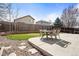 Spacious backyard with a stone patio, lush lawn, and a basketball hoop for outdoor fun at 6190 Sparrow Ave, Firestone, CO 80504