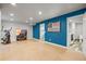 Spacious basement with finished floors, blue accent wall, and modern fitness equipment at 6190 Sparrow Ave, Firestone, CO 80504