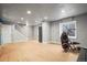 Basement area with neutral colored walls and floors, open staircase, and home gym equipment at 6190 Sparrow Ave, Firestone, CO 80504