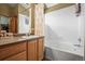 Bathroom featuring vanity with granite countertop, shower over tub, and tile flooring at 6190 Sparrow Ave, Firestone, CO 80504