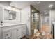 Remodeled bathroom featuring a vanity with a white countertop and a glass shower at 6190 Sparrow Ave, Firestone, CO 80504
