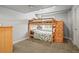 Bedroom with bunkbeds and built-in storage on neutral carpeting at 6190 Sparrow Ave, Firestone, CO 80504