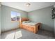 This bedroom is bright and airy with a built-in bed frame and neutral carpet flooring at 6190 Sparrow Ave, Firestone, CO 80504