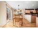 Dining area with a wooden table set, a pendant light fixture and a sliding door leading to the outside at 6190 Sparrow Ave, Firestone, CO 80504